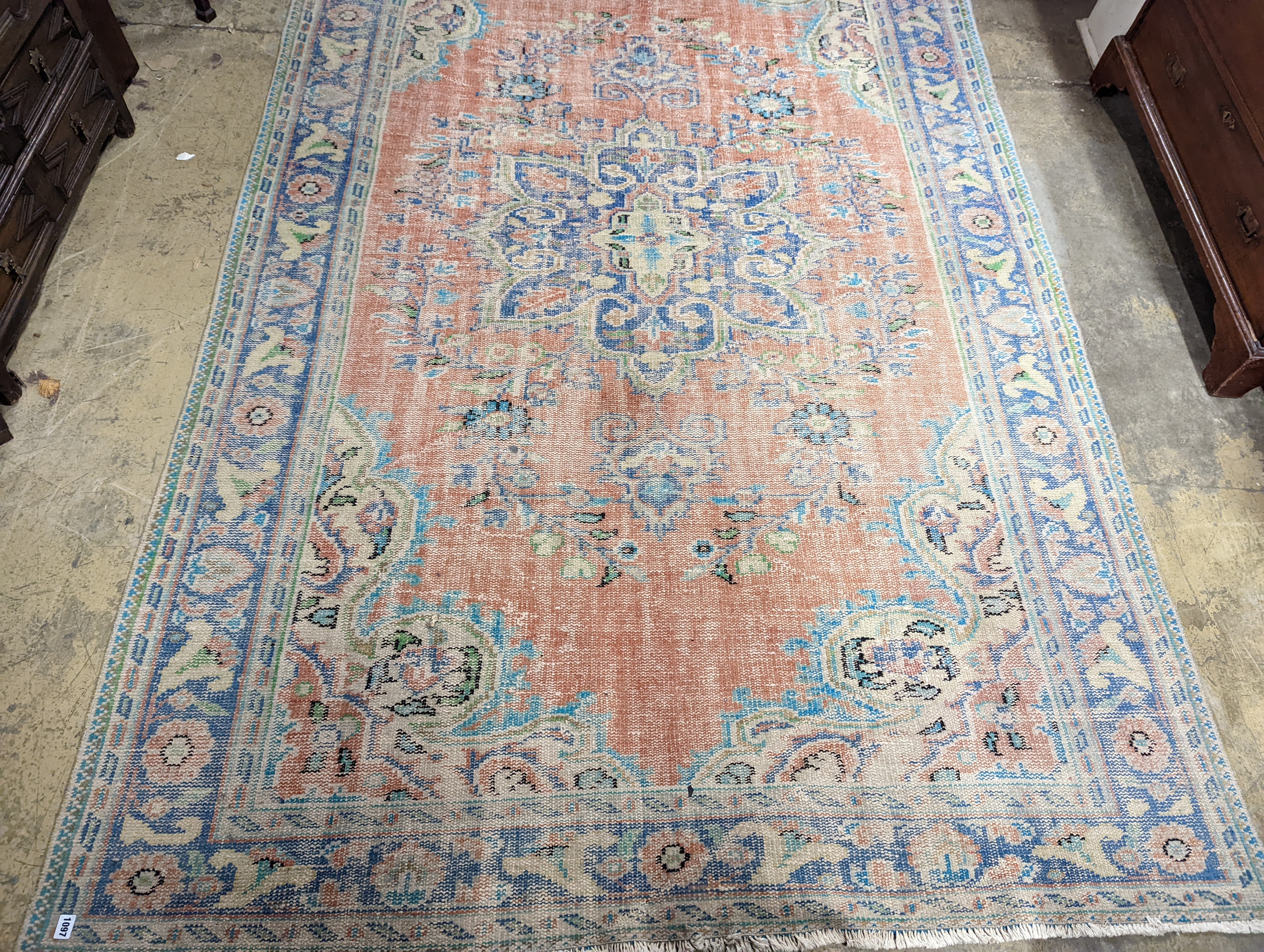 A North West Persian style faded wool carpet, 300 x 196cm